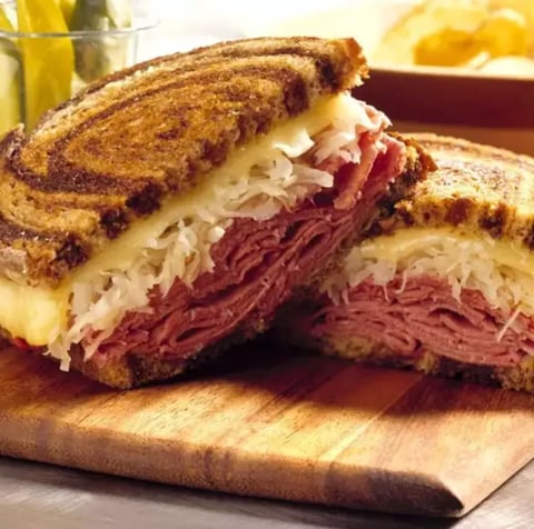 Half a sandwich filled with tender meat and melted cheese.