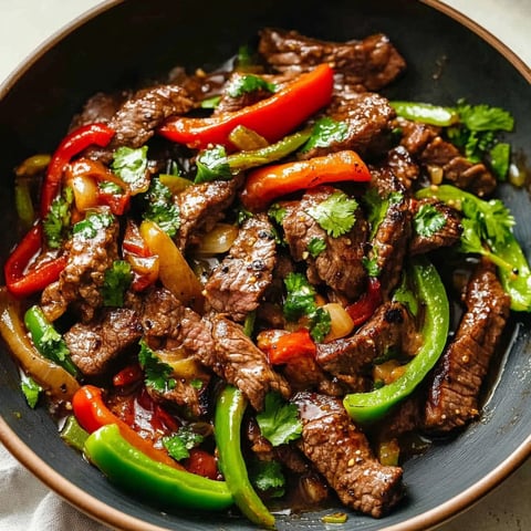 A bowl of Chinese pepper steak with various vegetables and meat.